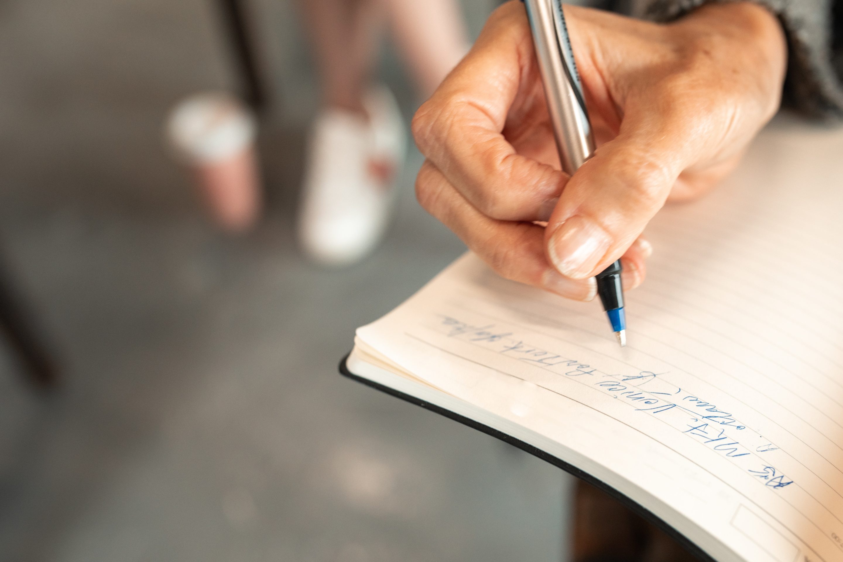 person-with-pen-paper collaborative meeting reviewing data