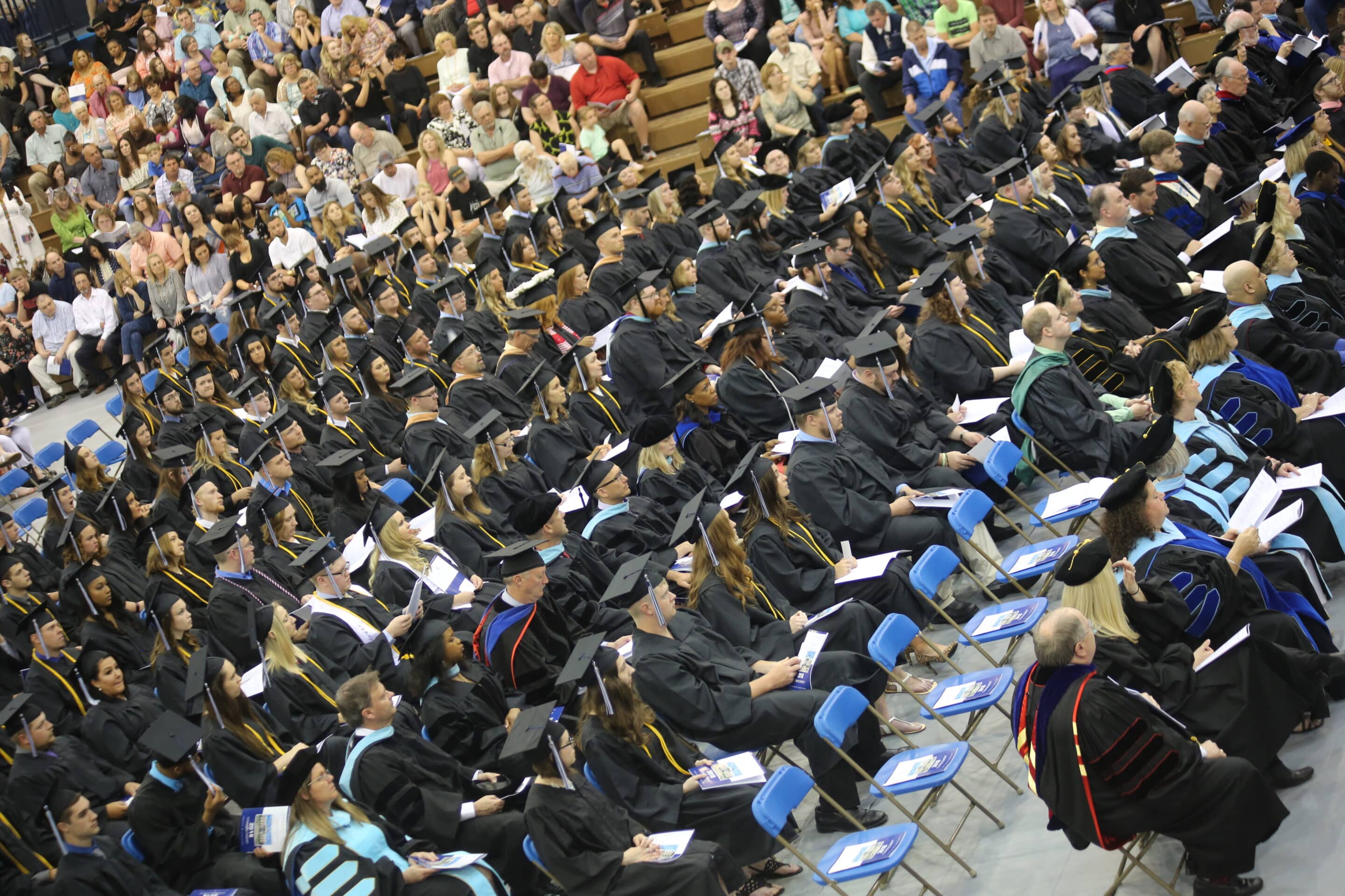 Students seated in Johnson Center during graduation ceremony.